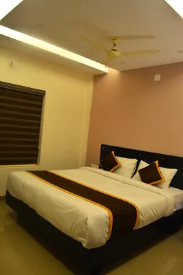 a bedroom with a large bed in a room at NEW MOUNT RESIDENCY in Sultan Bathery