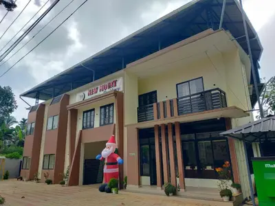 a cat in the hat standing outside of a building at NEW MOUNT RESIDENCY in Sultan Bathery
