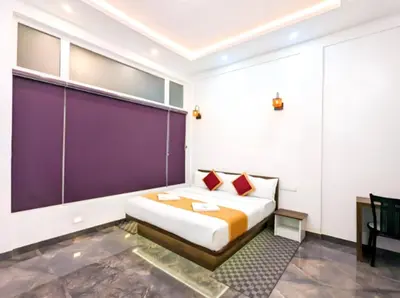 a bedroom with a bed and a purple wall at Wayanad Valentine Pool Resort in Sultan Bathery
