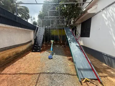 an empty playground in a building with a slide at Empire Private Pool Villa in Kalpetta