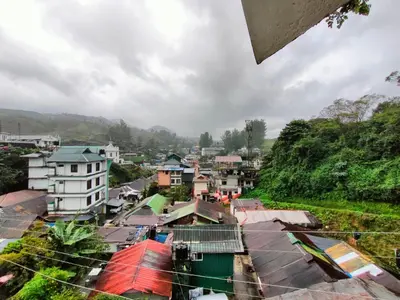 a view of a city with houses and buildings at Munnar Kaippalli Budget Homestay in Munnar