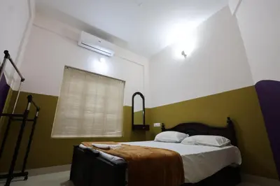 a bedroom with a bed with green and white walls at Wayanad regal residency in Kalpetta