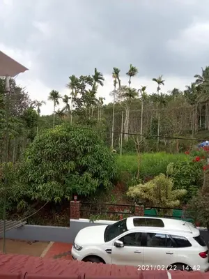 a white car parked in a parking lot at Anna homestay in Chekadi