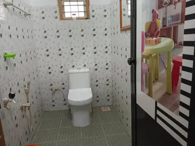 a bathroom with a toilet and a sink at Anna homestay in Chekadi