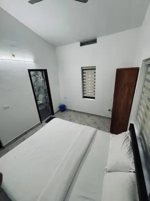 a bedroom with a large bed and a window at Chills homestay in Kalpetta