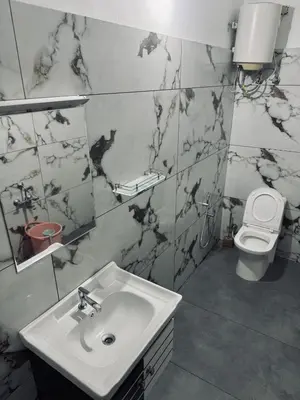 a bathroom with a sink and a toilet at Chills homestay in Kalpetta