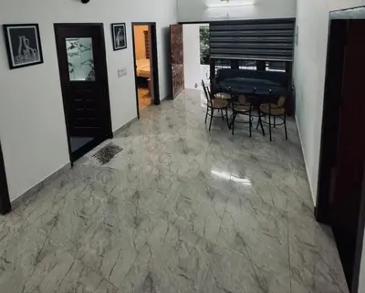 a hallway with a table and chairs in a room at Chills homestay in Kalpetta