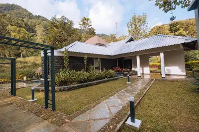 a house with a garden in front of it at Elixir Woods Luxury Resort And Spa, Munnar in Munnar