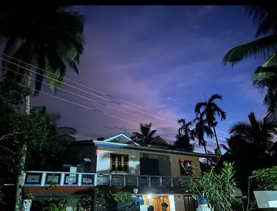a house at night with palm trees at Chills homestay in Kalpetta