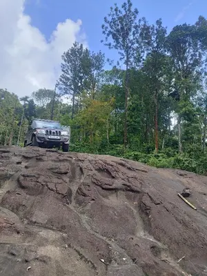 a jeep parked on top of a large rock at Chills homestay in Kalpetta
