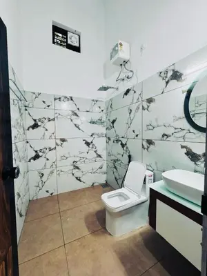 a bathroom with a toilet and a sink at Chills homestay in Kalpetta