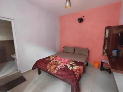 a small bedroom with a bed and a bathroom at Ooty Prakash Residency in Ooty