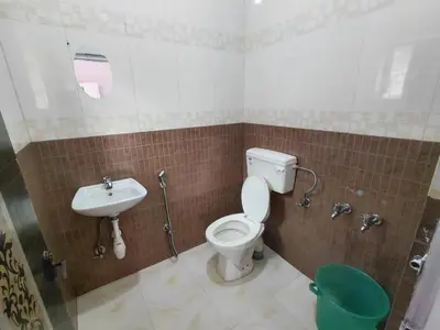 a bathroom with a toilet and a sink at Ooty Prakash Residency in Ooty