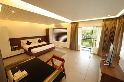 a hotel room with a bed and a television at jungle view resort in Mananthavady