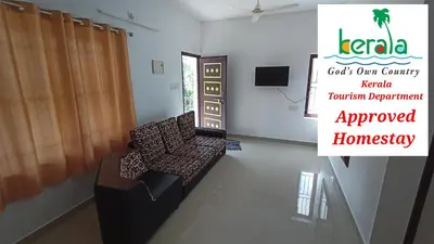 a room with a chair and a sign that reads consult our country trauma department approved at Space villa Homestay in Irimbranallūr