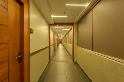a corridor of an office with a long hallway at Hotel Stay Bella Kozhikode in Kozhikode