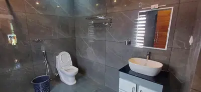 a bathroom with a toilet and a sink at Empire Single Bedroom Villa with Common Pool in Meenangadi