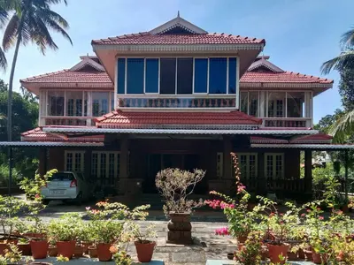 a house with a car parked in front of it at Pournami Home Stay in Trichūr