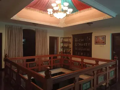 a room with a staircase and a chandelier at Pournami Home Stay in Trichūr
