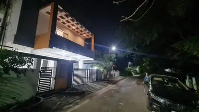 a car parked in front of a house at night at Kamalam 3BHK Villa 1AC and 2 Non AC Bedrooms in Coimbatore