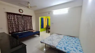 a bedroom with a bed and a couch in it at Kamalam 3BHK Villa 1AC and 2 Non AC Bedrooms in Coimbatore