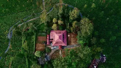 an aerial view of a house in the middle of a forest at Harris Holiday Inn in Vālpārai