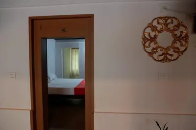 a room with a bedroom with a mirror and a bed at Best Heritage Home in Iritti