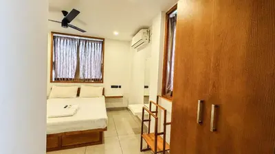 a small room with a bed and a window at Rose Garden at Rajagiri Hospital in Ernakulam