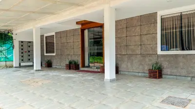 a front porch of a house with potted plants at Rose Garden at Rajagiri Hospital in Ernakulam