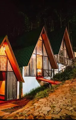 a painting of a house with a river at Vattavada Jungle Resort in Munnar