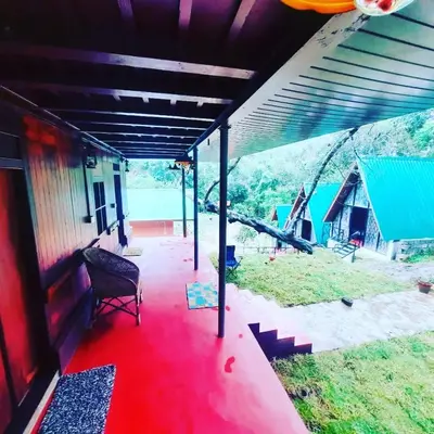 a house with a red floor and a red carpet at Vattavada Jungle Resort in Munnar