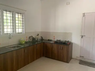 a kitchen with a sink and a counter top at Casa Ganesha beach villa in Irimbranallūr