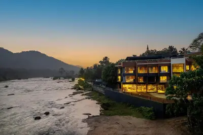 a building on the banks of a river at Sterling Athirappilly in Athirappilly