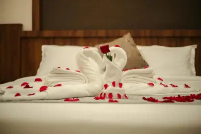 a bed with two swans made out of towels at ARIAT AVENUE in Wayanad
