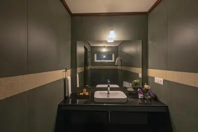 a bathroom with a sink and a mirror at Emerald by Nature Resorts and Stays in Ooty