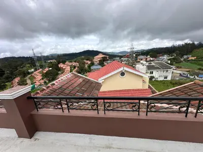 a balcony with a view of a town at HAILSTONE HOME STAY in Ooty