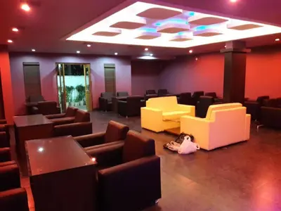 a waiting room with couches and chairs and a ceiling at HOTEL SRIVATSA REGENCY in Pudunagaram