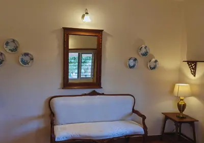 a room with a chair and plates on the wall at Wild Pastures by Nature Resorts and Stays in Masinagudi