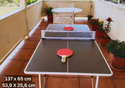 a ping pong table on the balcony of a house at Wild Pastures by Nature Resorts and Stays in Masinagudi