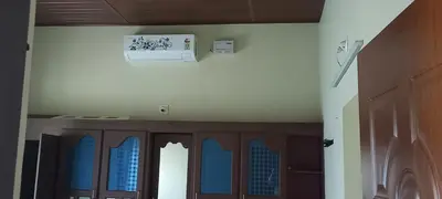 a hallway with a door with blue windows and a ceiling at CITADEL HOLIDAY HOME in Vythiri