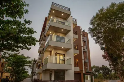 an apartment building with balconies on a street at Treebo Samanvaya Retreat, Mysore in Mysore