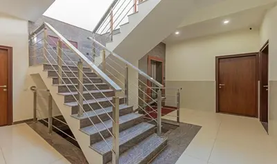 a staircase in a house with a wooden door at Treebo Samanvaya Retreat, Mysore in Mysore