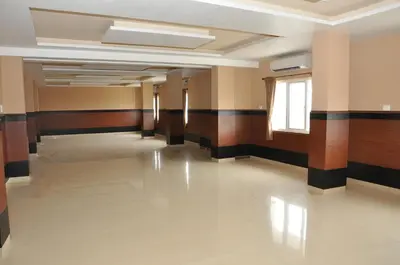 an empty hallway in a building with a window at Hotel Royal Chambers in Coimbatore