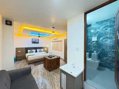 a hotel room with a bed and a bathroom at Marhaba plaza in Kozhikode