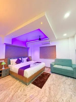 a bedroom with a large bed and a purple ceiling at Marhaba plaza in Kozhikode