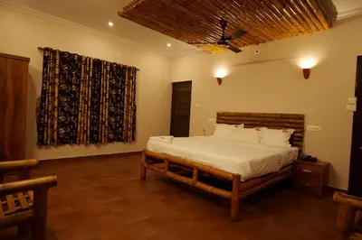 a bedroom with a bed in a room with a window at The Alpine Inn in Gūdalūr