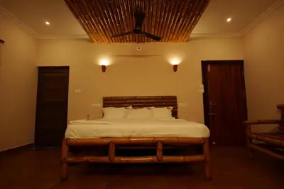 a bedroom with a bed with a ceiling at The Alpine Inn in Gūdalūr