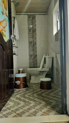 a bathroom with a toilet and a sink at Achus Holidays in Munnar