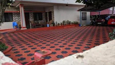 a red and black floor in front of a house at Delight Homestays Coorg in Kushālnagar