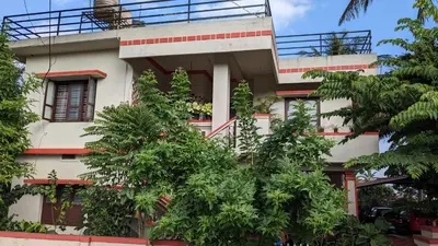 a building with trees in front of it at Delight Homestays Coorg in Kushālnagar